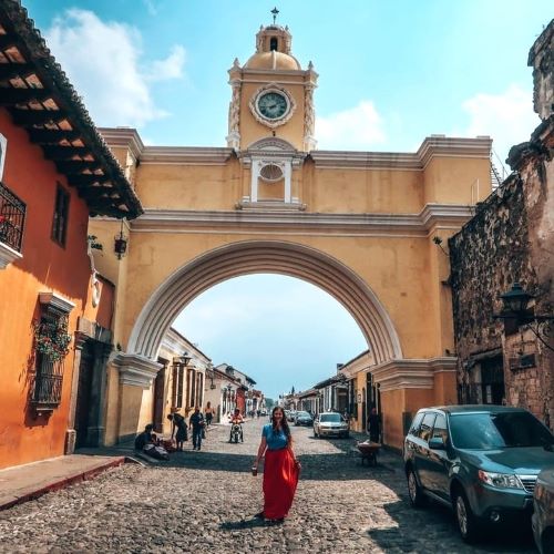 Photo of the Santa Catalina Arch with a woman in a red dress